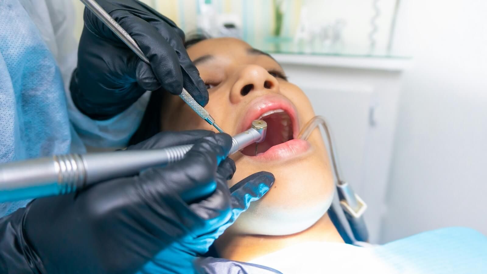 A dental professional treating a patient during a clinical procedure